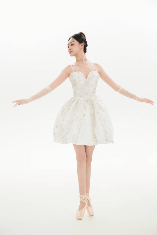 白色背景下跳芭蕾舞的亚洲少女