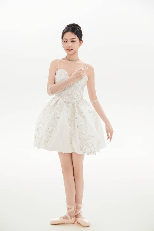 白色背景下跳芭蕾舞的亚洲少女