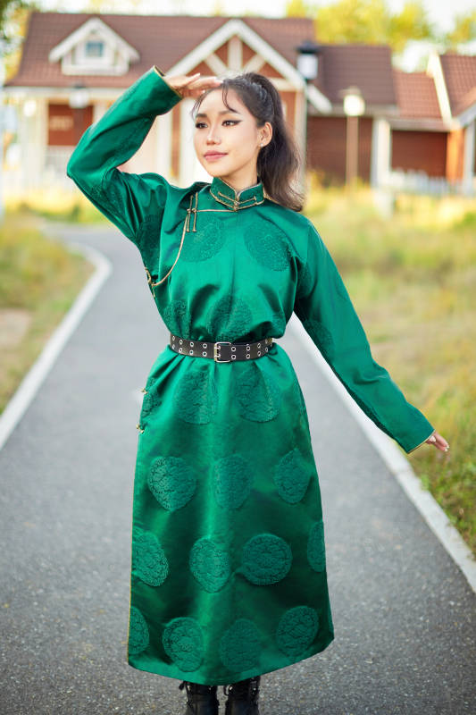 室内穿着绿色蒙古袍的蒙古族年轻女性