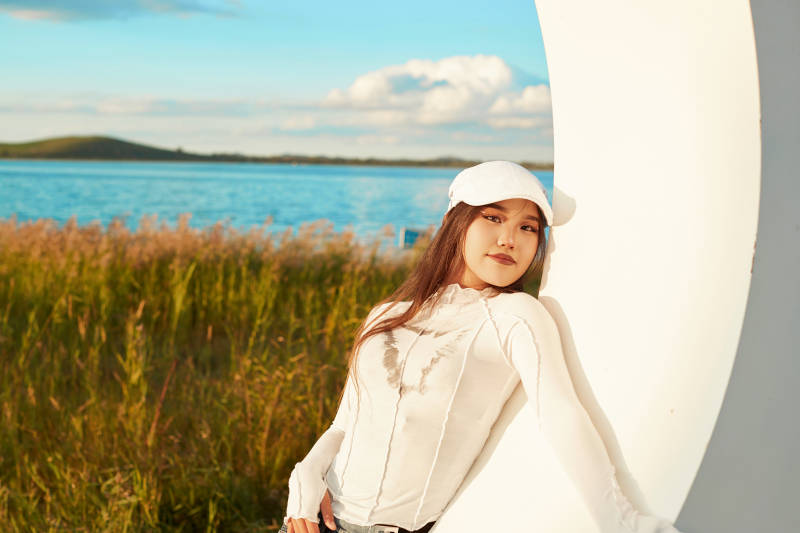 在旅游区湖边打卡点拍照的美女