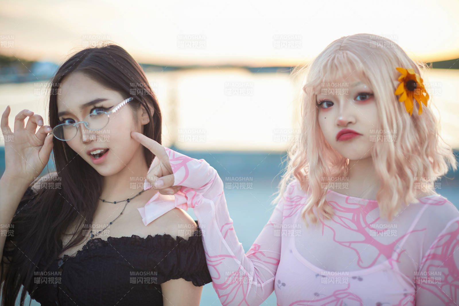 在旅游区湖边打卡点拍照的美女闺蜜