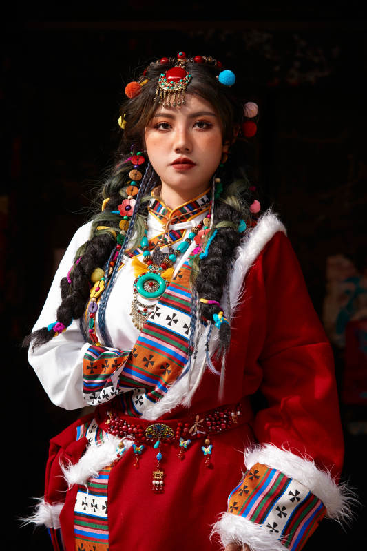 身穿藏族服饰在古城拍照的少女