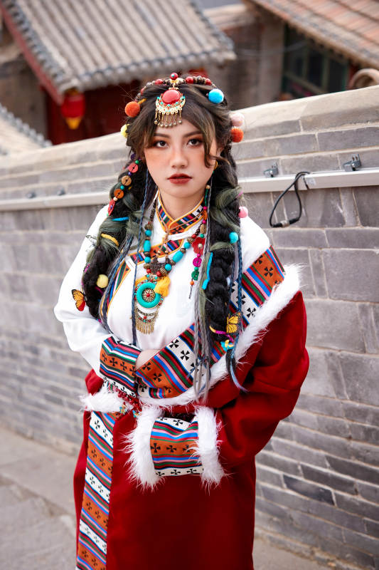 身穿藏族服饰在古城拍照的少女