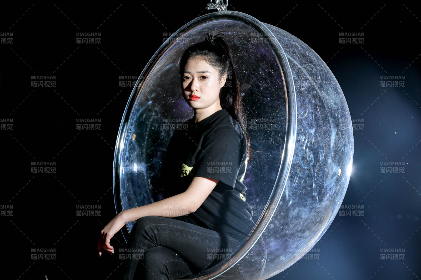 夜晚坐在透明秋千上燃放仙女棒的可爱少女