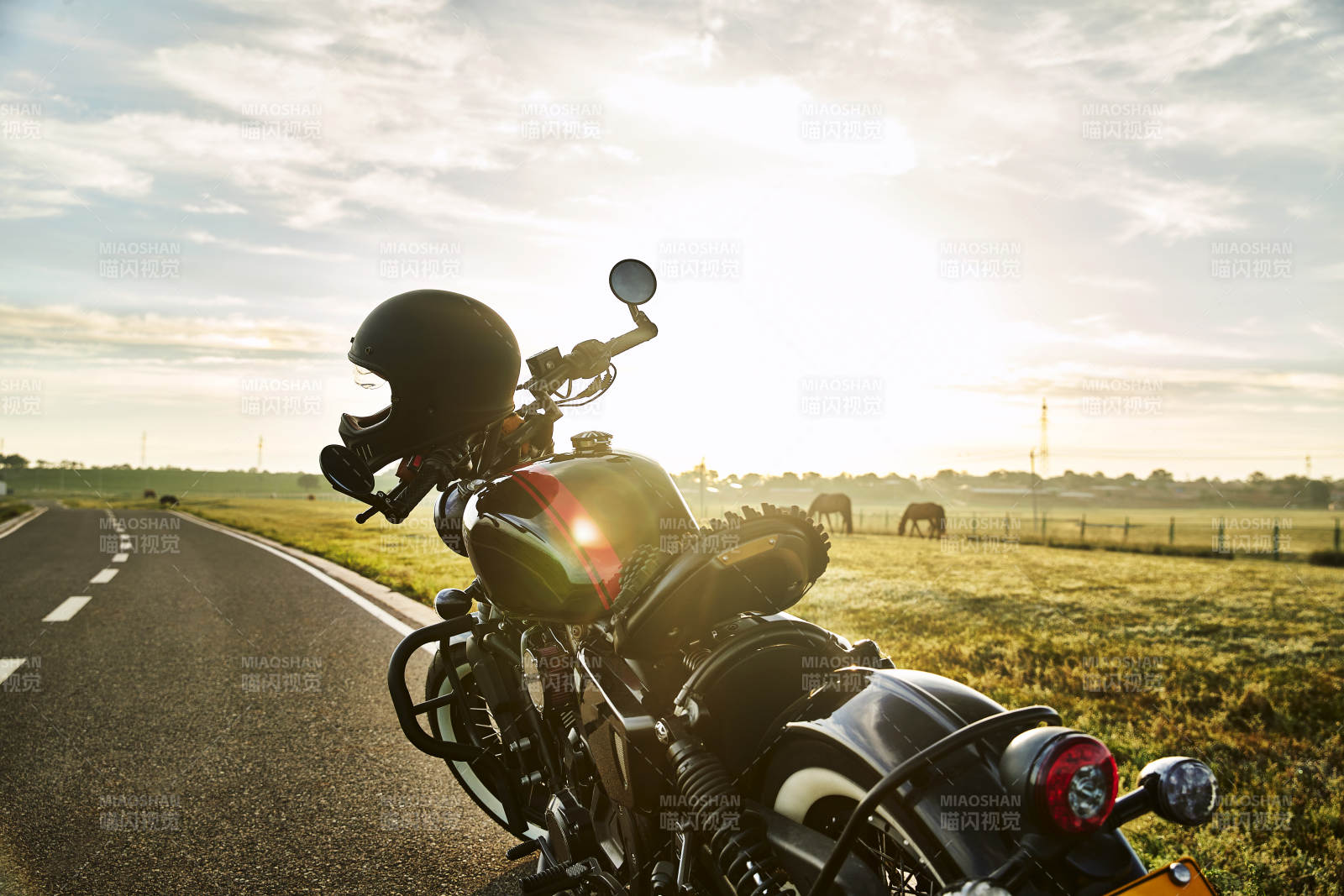 清晨朝阳下停靠在公路上的复古摩托车