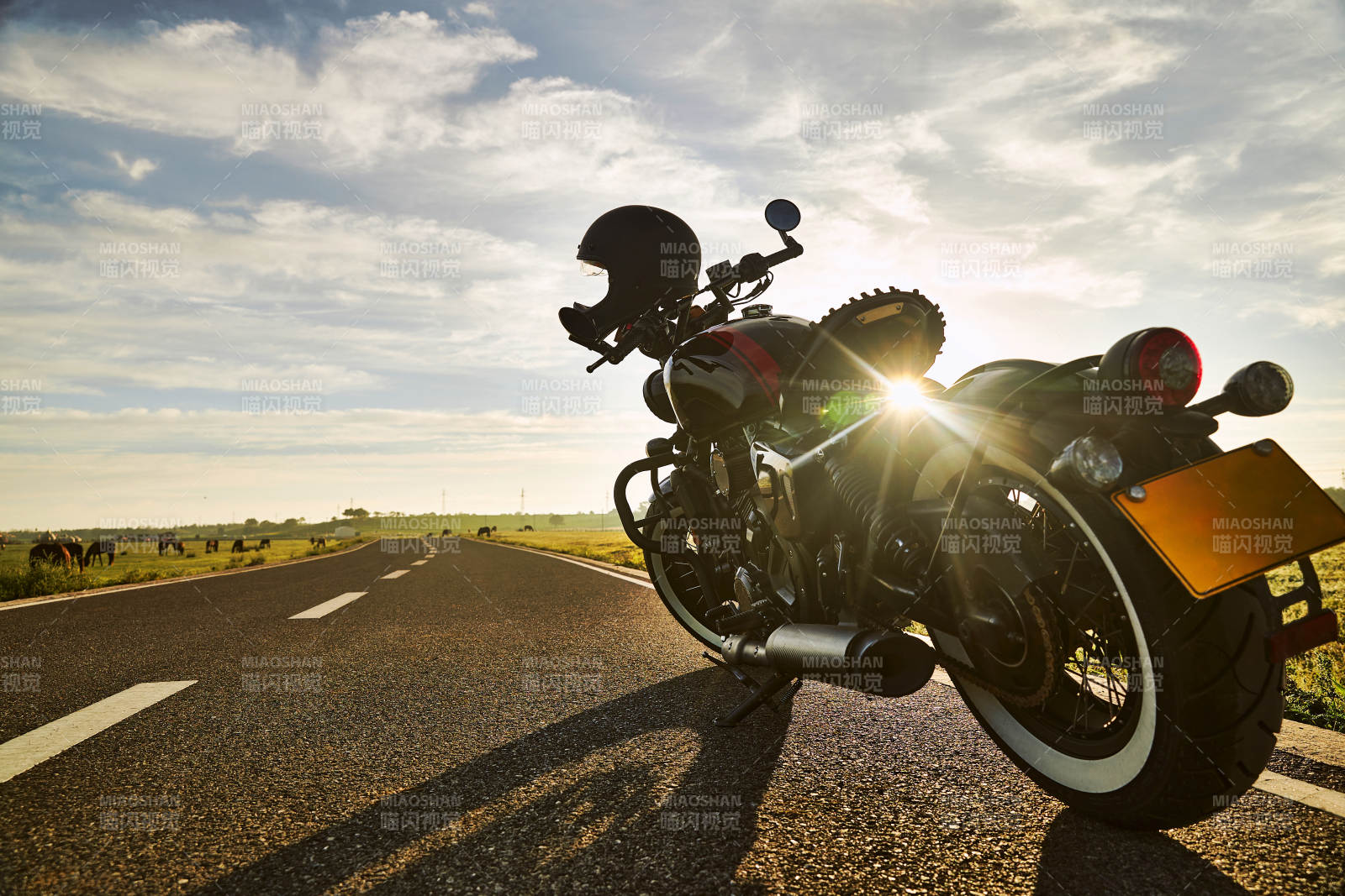 清晨朝阳下停靠在公路上的复古摩托车