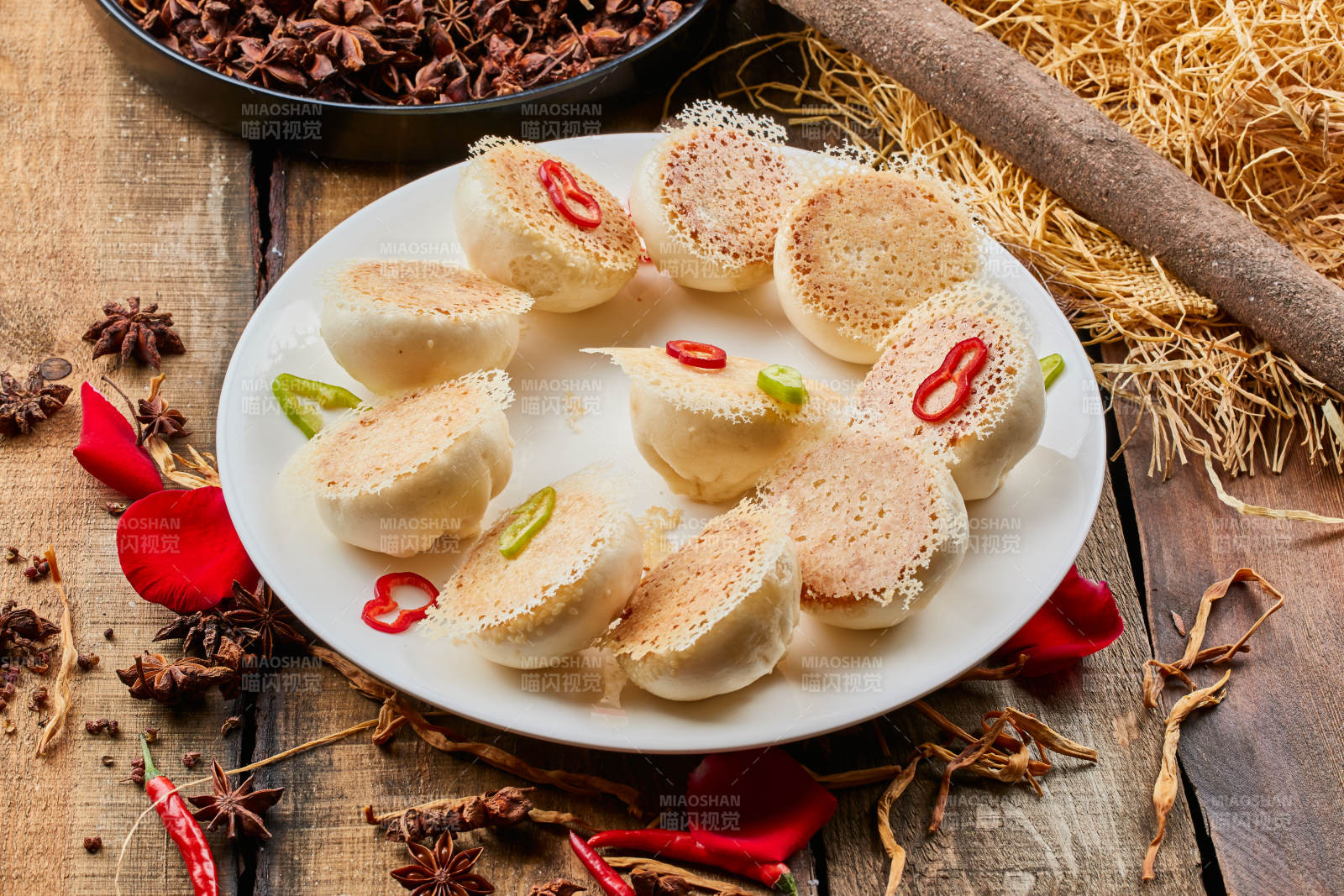 陈旧木板上的圆瓷盘装的水煎渔网酱肉包