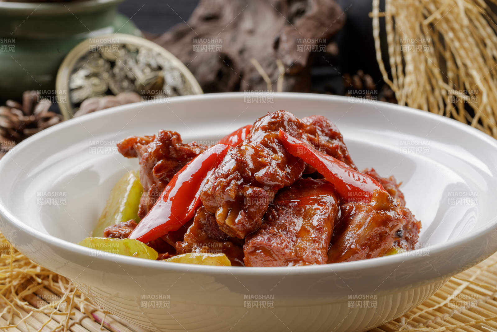 寿司帘上的白色砂锅装的酱小排