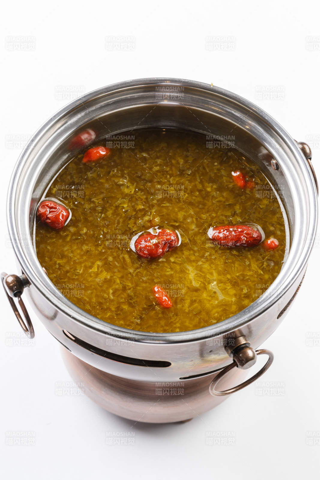 白色背景上的小火鍋裝的雪菜牛油鍋底