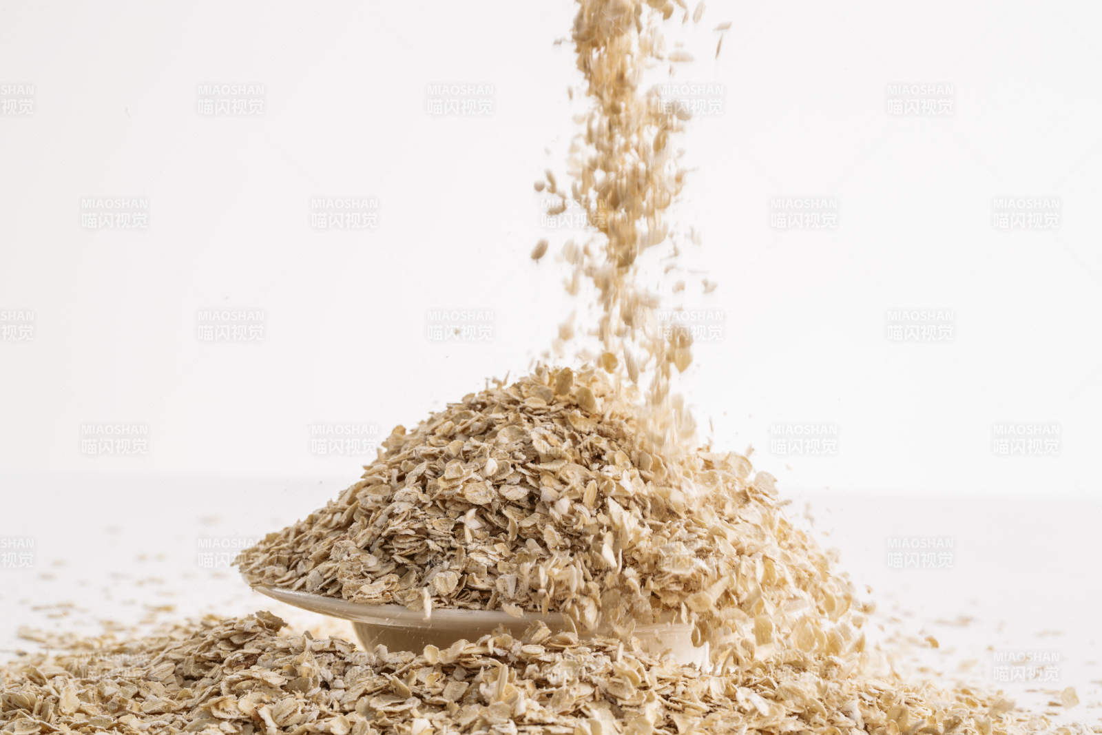 倾倒在白色背景上的健康食品燕麦片