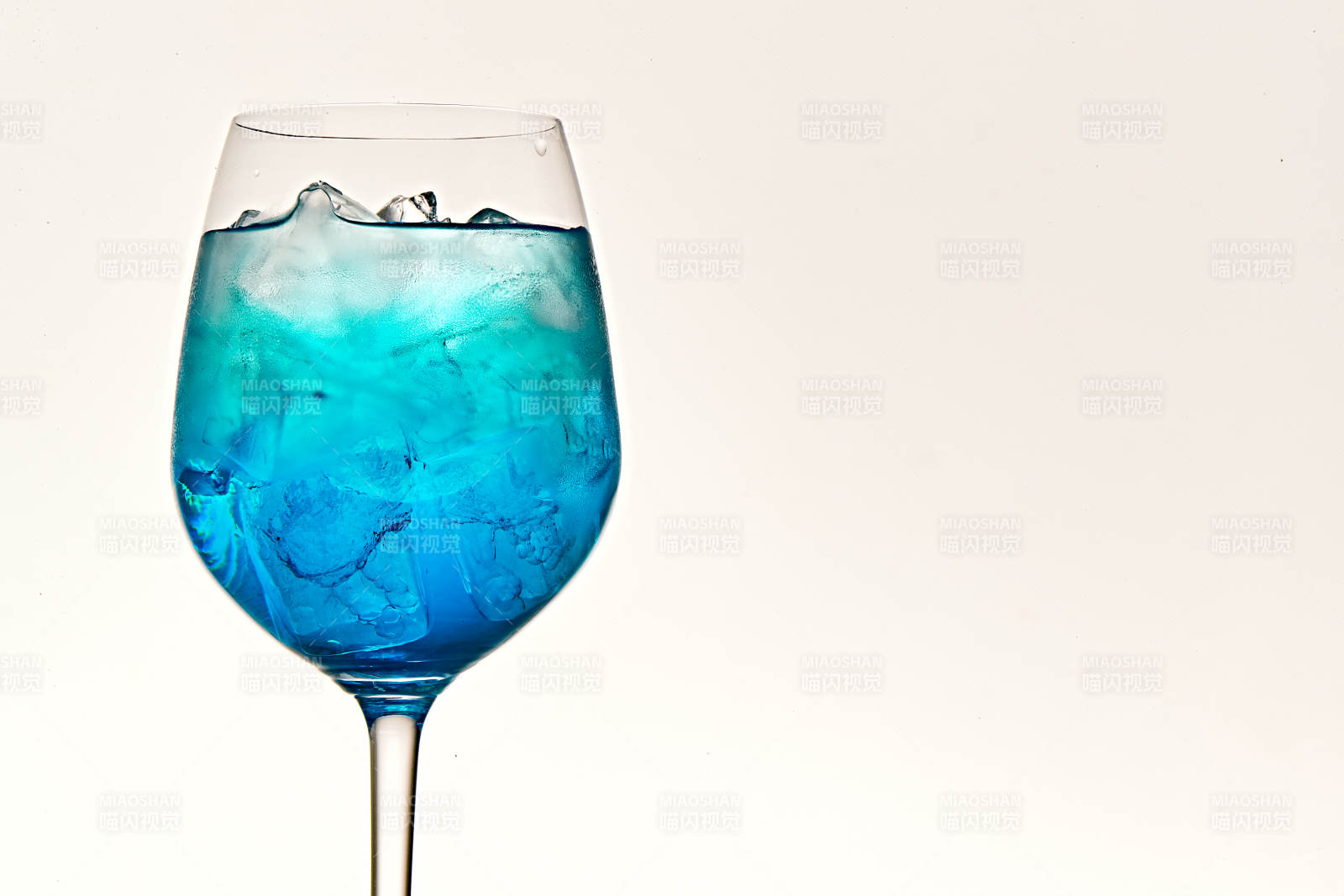 酒杯中的清凉蓝橙汁百加得调制的鸡尾酒