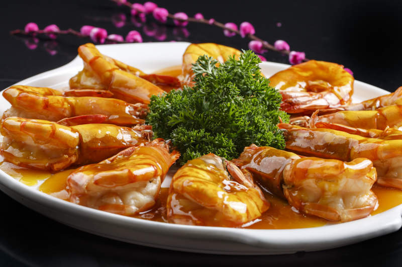 白色瓷盘装的酸甜汁油炸开背虾