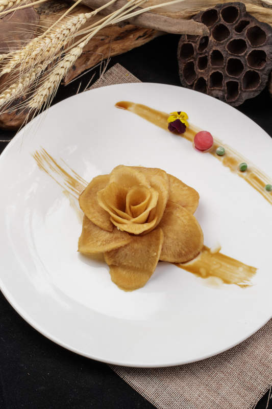 白色瓷盘装的制作精美的腌萝卜牡丹花