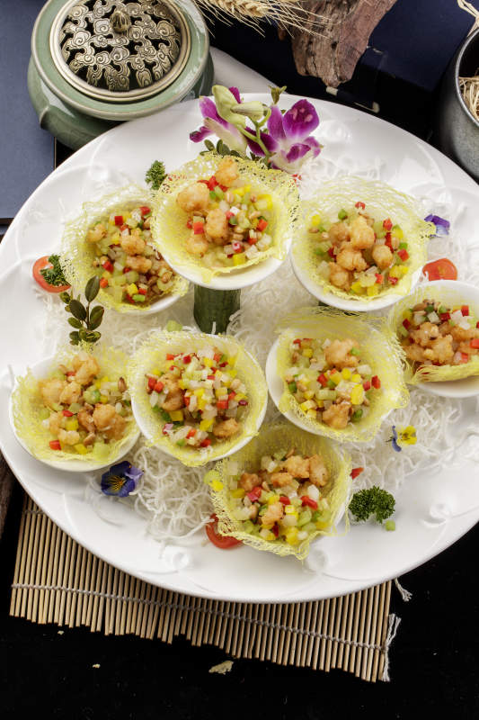 蒜香金盏牛仔粒摆放在樟木砧板上-摄影图