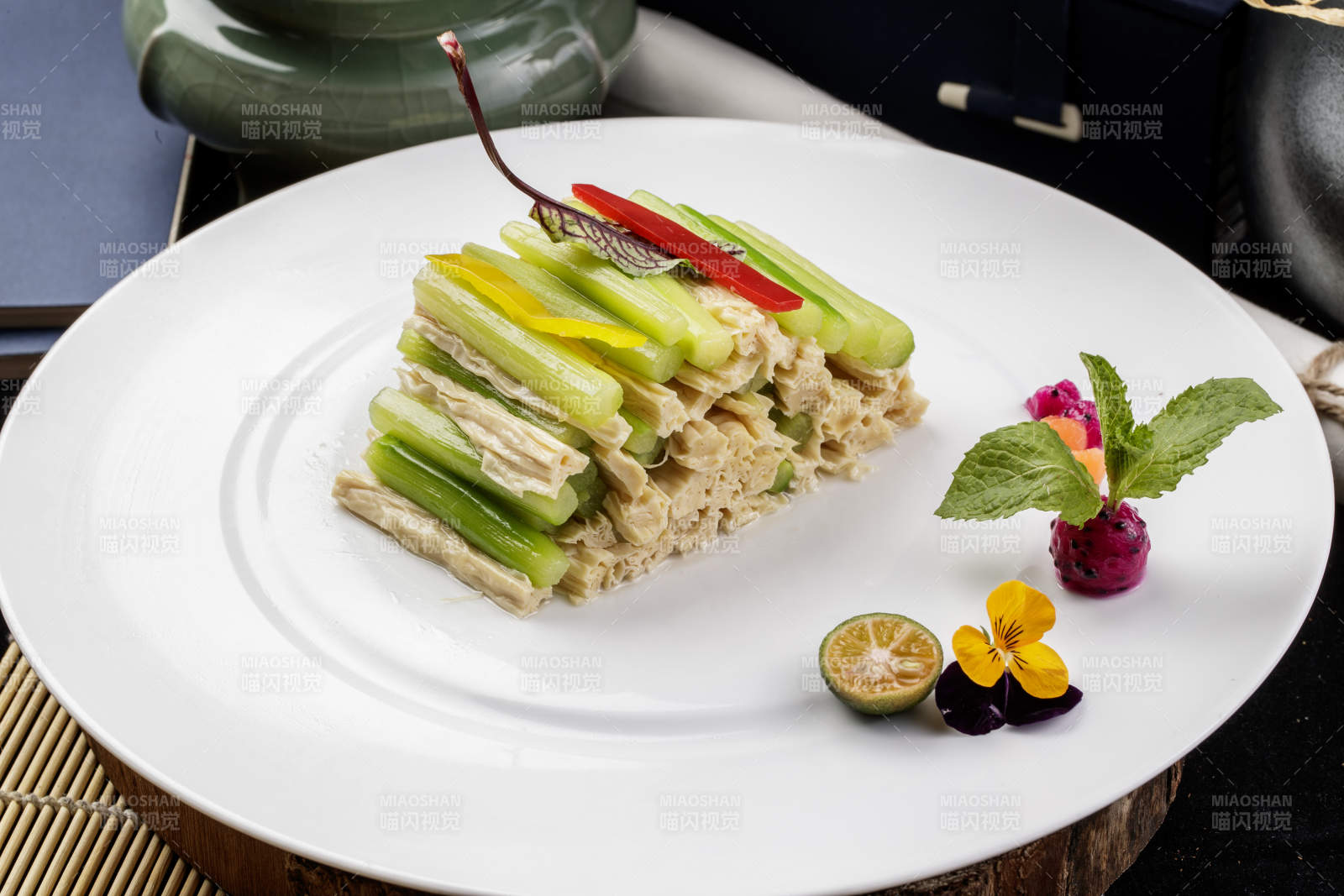 圆形白色瓷盘装的乳瓜腐竹摆放在樟木砧板上-摄影图