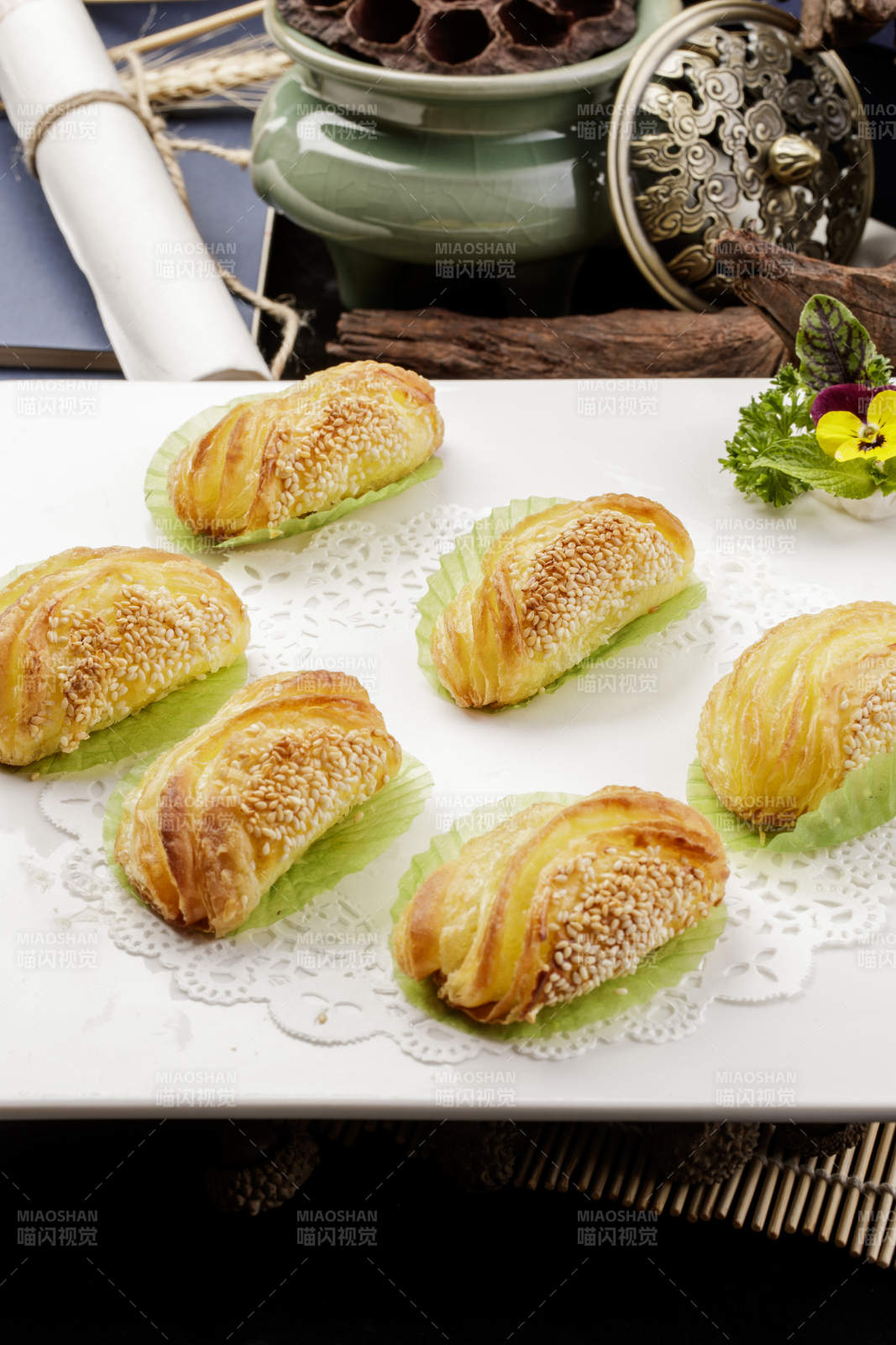 方形瓷盘装的半打榴莲酥摆放在黑色背景上