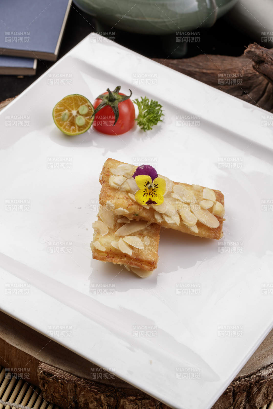 制作精良的北派鱼泥杏仁酥摆放在樟木砧板上-摄影图