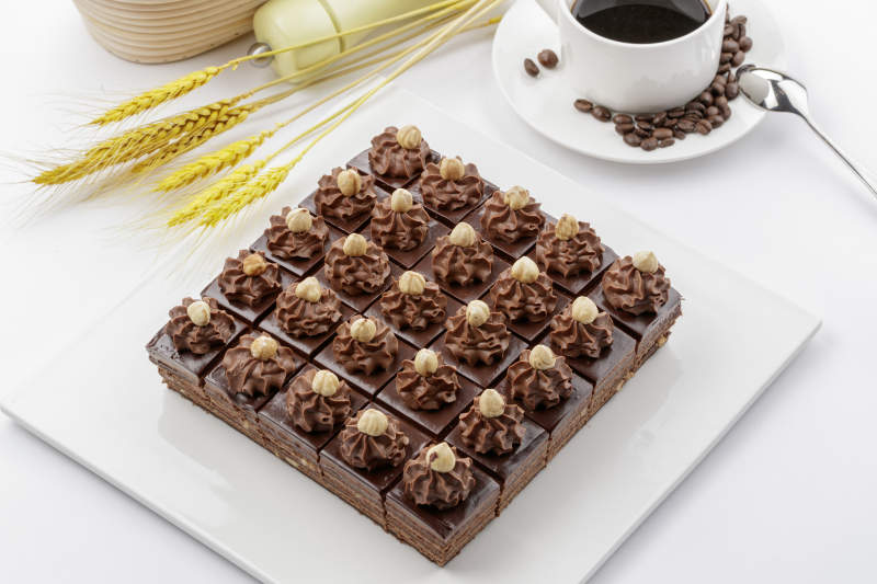 坚果巧克力慕斯蛋糕摆放在白色背景上