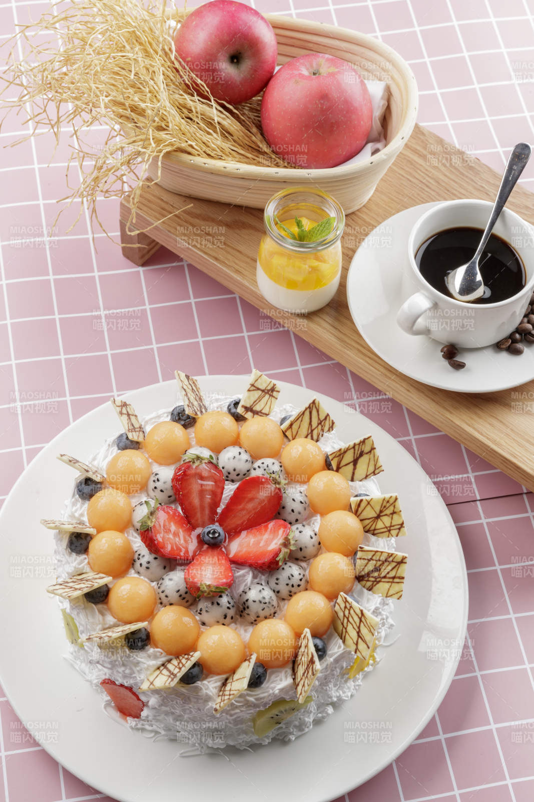 奶油缤纷水果蛋糕摆放在粉色背景上