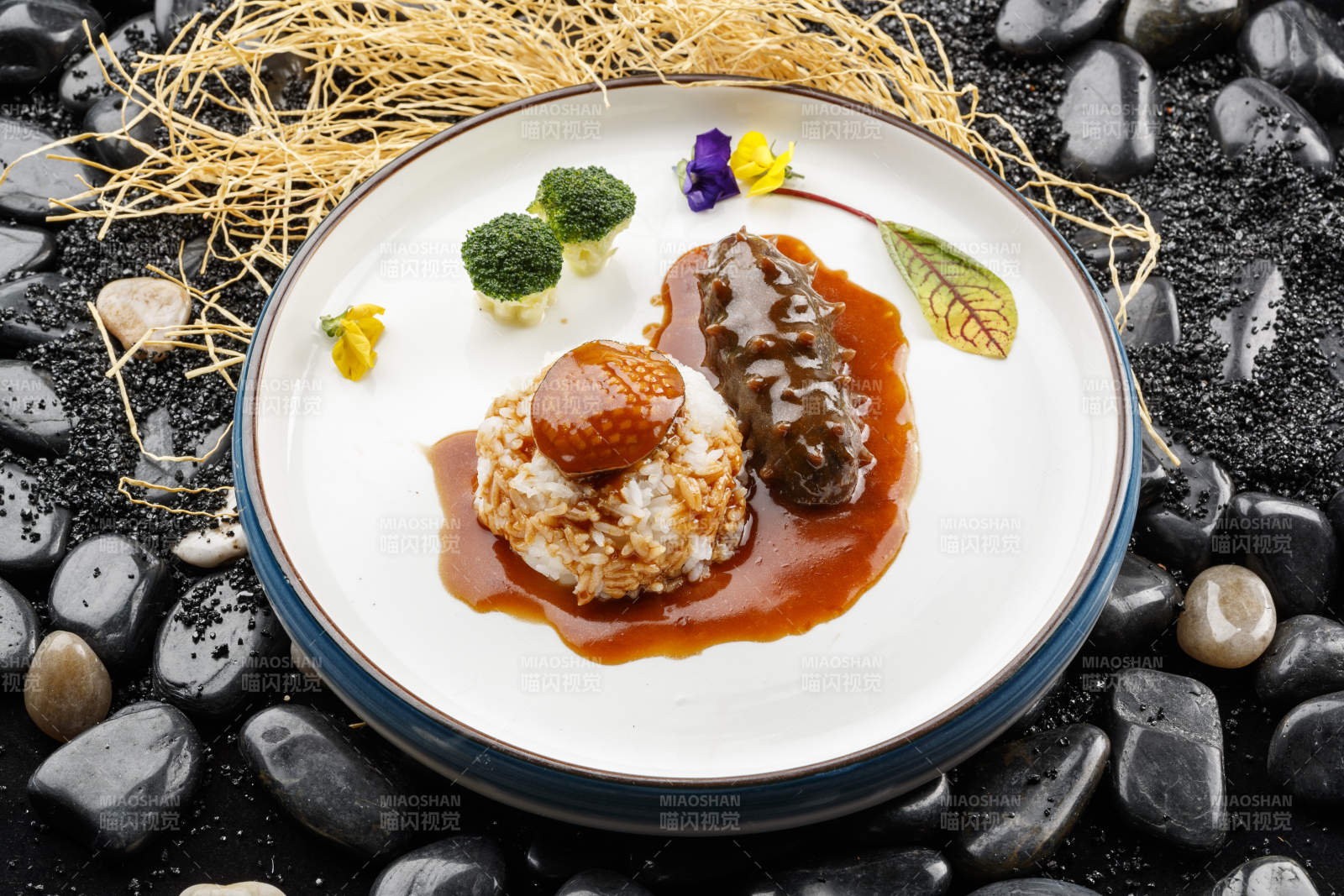 鮮鮑魚遼參撈飯擺放在黑色鵝卵石上