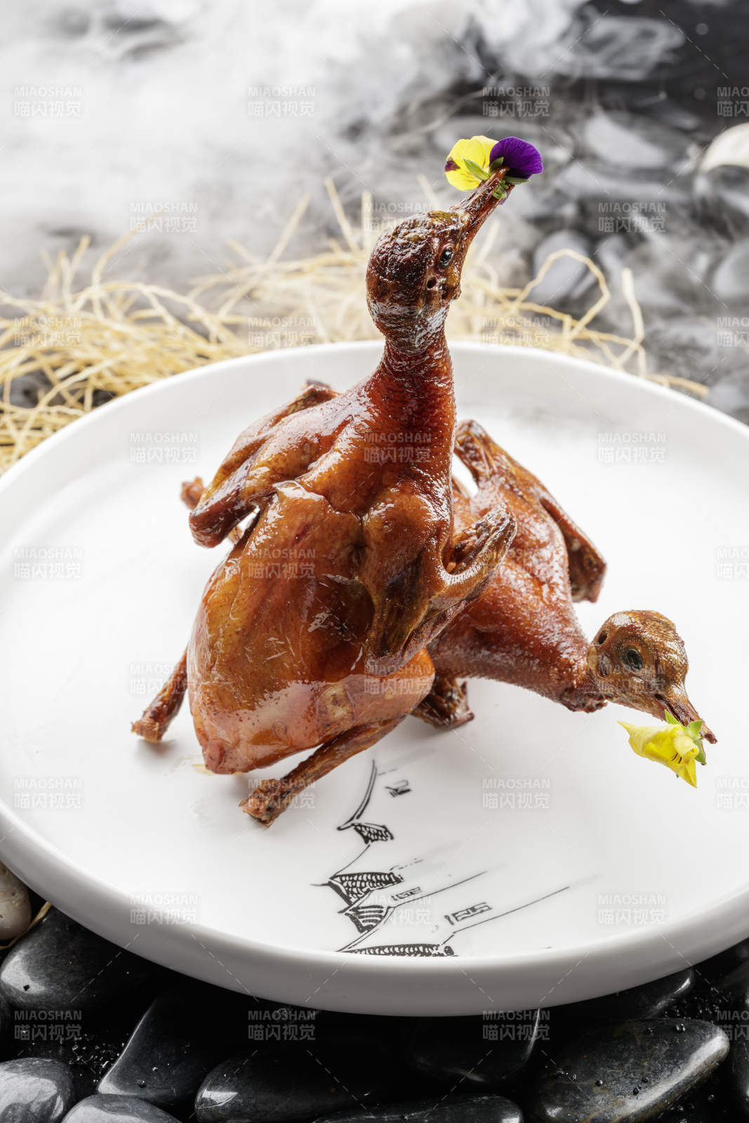 白色圆盘装的生炸乳鸽摆放在黑色鹅卵石上