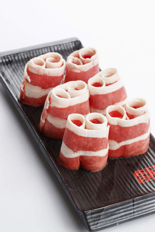 長方形黑色瓷盤裝的羊五花卷