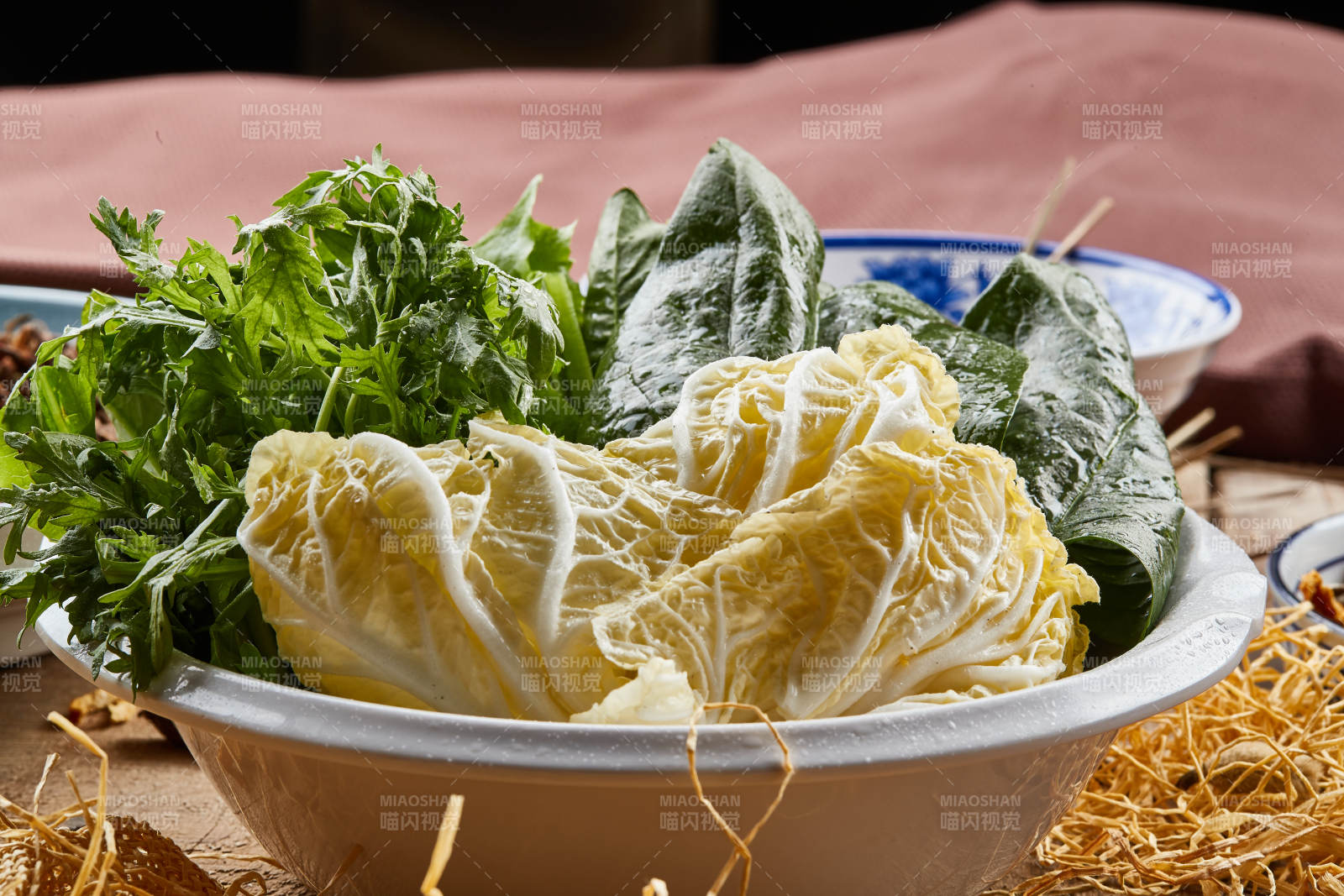 白色瓷盆装的火锅涮菜茼蒿白菜菠菜