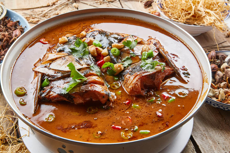 大型器皿装的家炖野生大鱼头配米饭