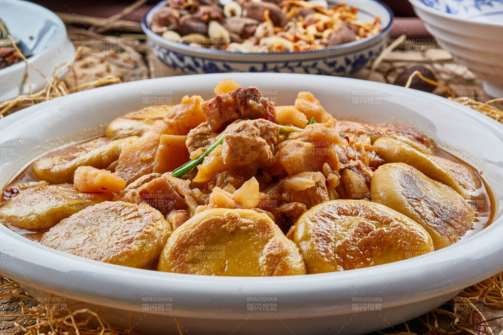 圓瓷盤裝的農家燉菜配拿糕