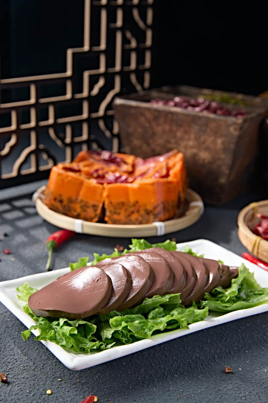 白色瓷盘装的火锅食材鸭血切片