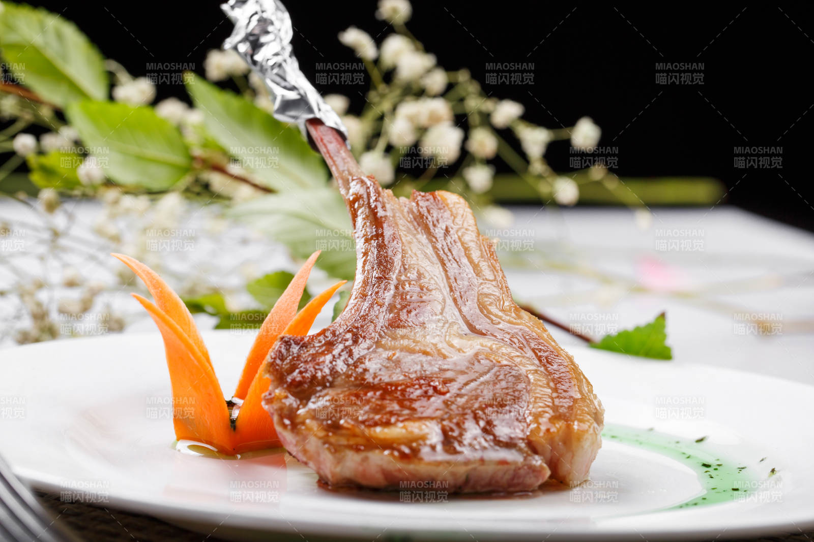 圆形白瓷盘装的波尔多法式铁板羊排摆放在餐垫上