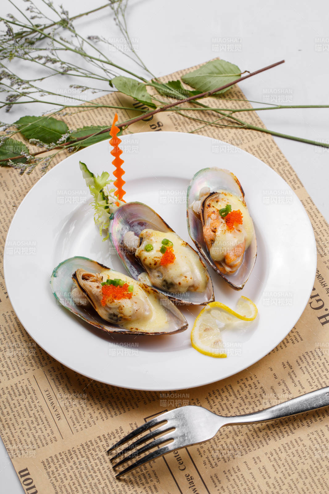 圆形瓷盘装的马苏里拉芝士焗青口贝贻贝摆放在英文包装纸上图片