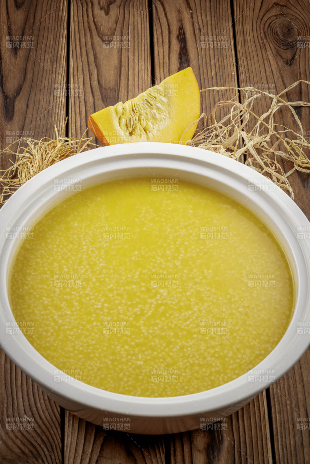 白色湯盆裝的金瓜小米粥
