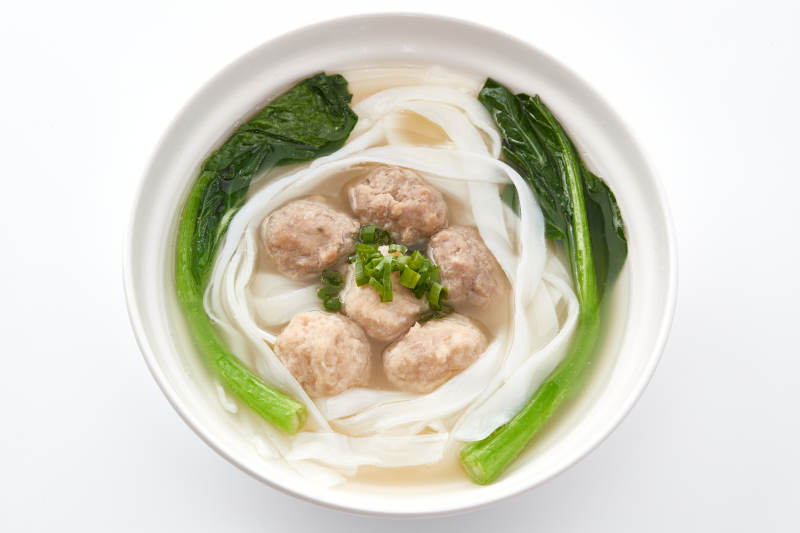 白色瓷碗裝的廣式河粉配牛丸