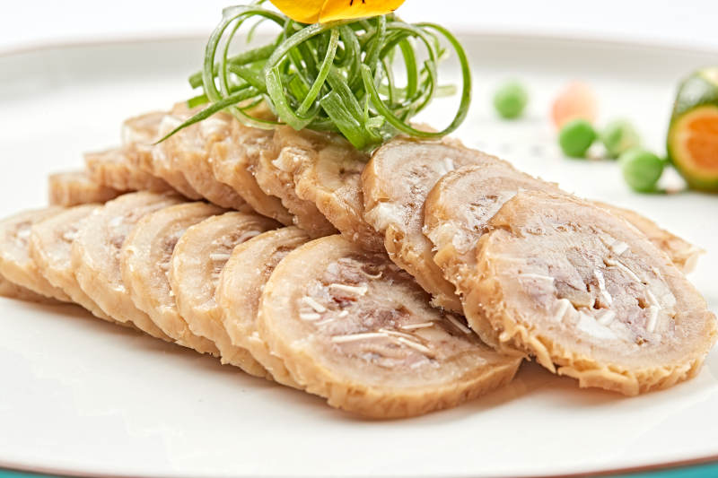 白色瓷盘装的鱿鱼压猪肚切片-摄影图