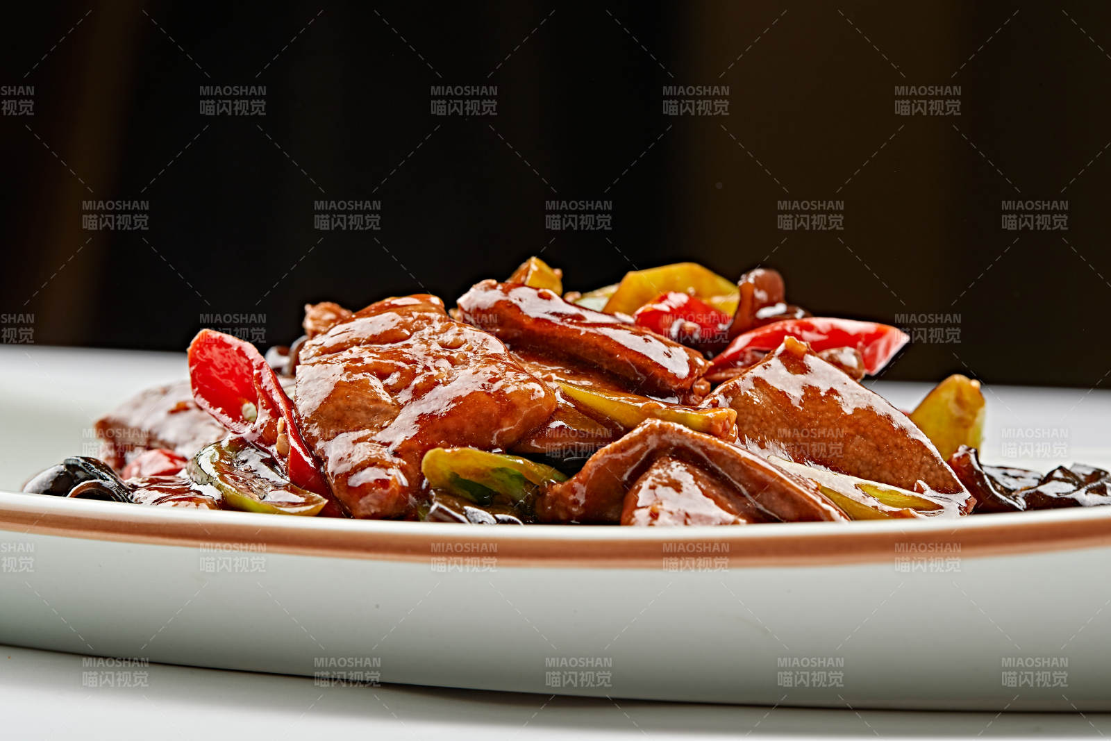 白色瓷盘装的木耳辣椒炒猪肝