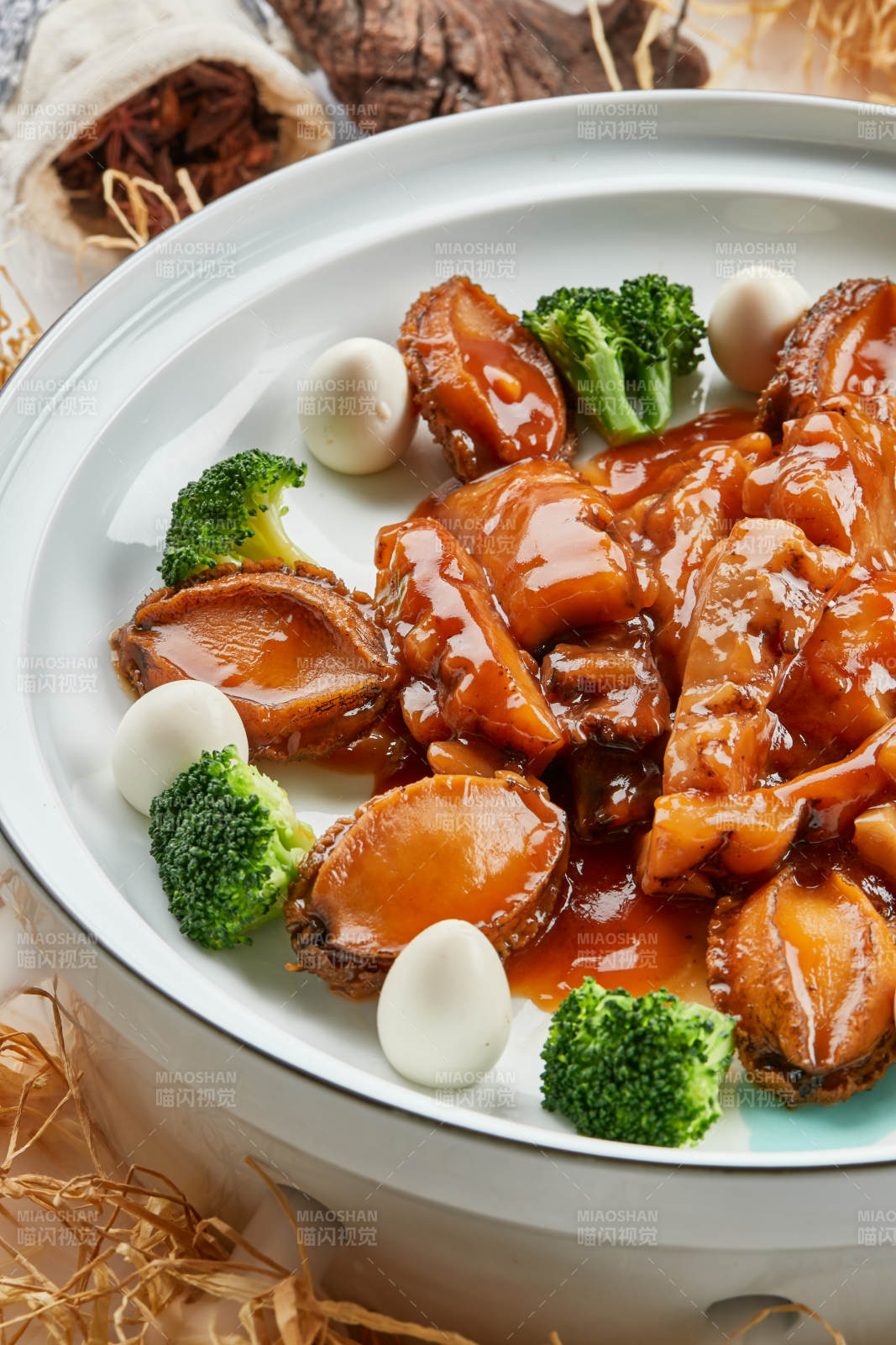 精美餐具装的浇汁鲜鲍鱼烧梅花参