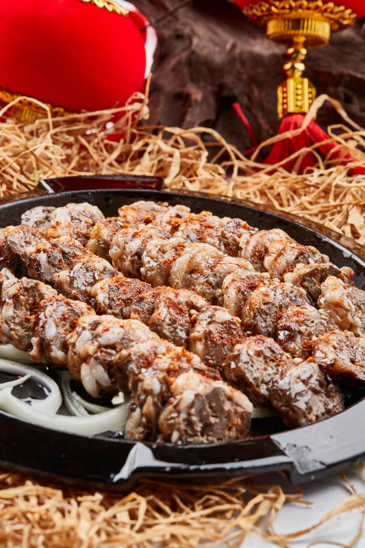 黑色铁盘装的香烤裹油羊肝