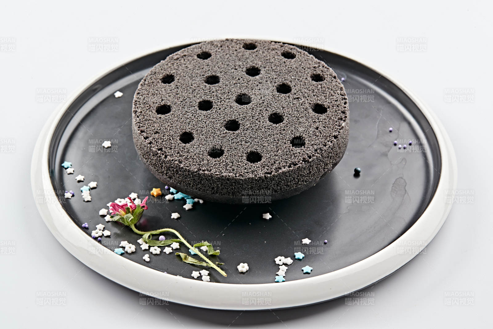 精美餐具装的竹炭粉黑米面蜂窝米糕