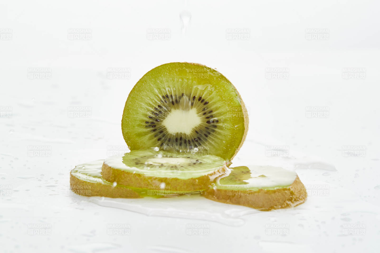 白色背景上摆放的水润猕猴桃切片