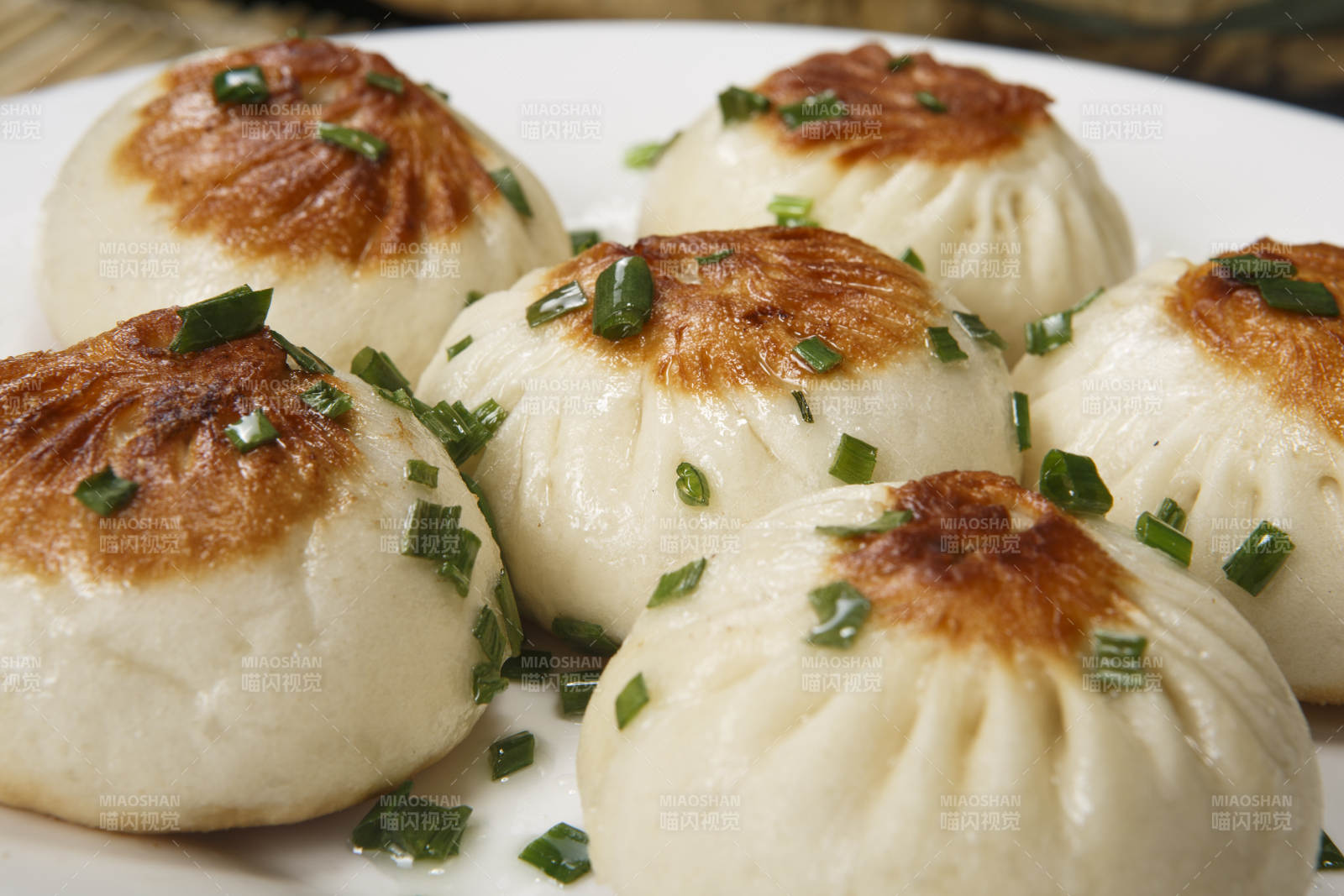 圓瓷盤裝的的海派生煎包