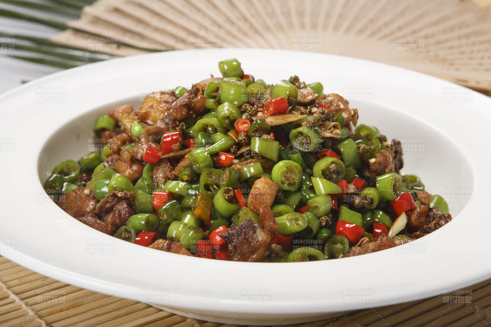 白色瓷盘装的米椒爆山鸡-摄影图