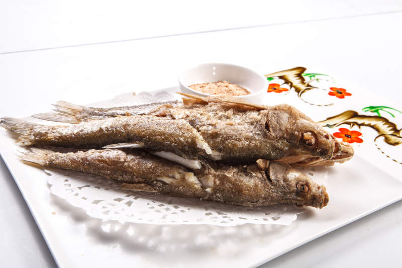 白色瓷盘装的蘸粉干炸深海大黄鱼
