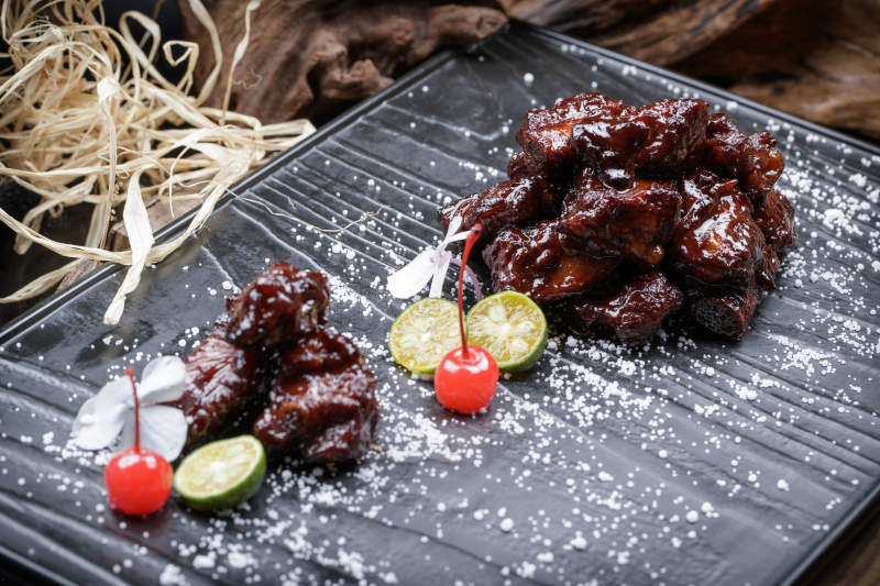 蜜汁叉烧小排骨摆放在樟木砧板上