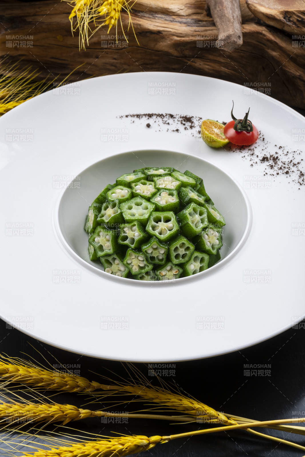 圓形瓷盤裝的撈汁鮮秋葵擺放在黑色背景上