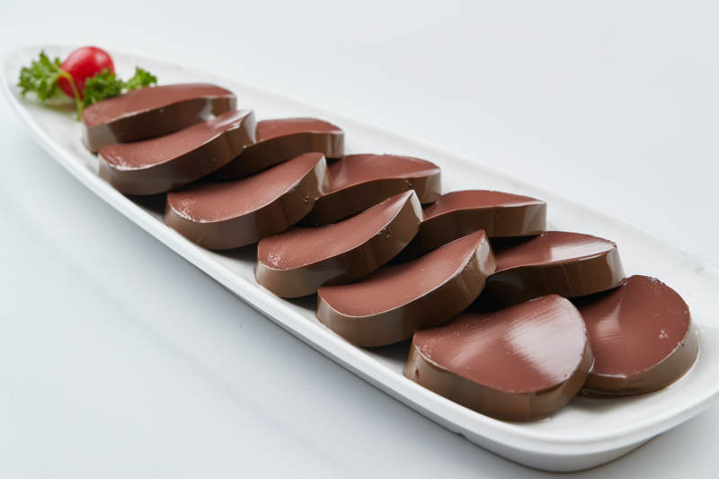 白色瓷盘装的的火锅食材鸭血切片