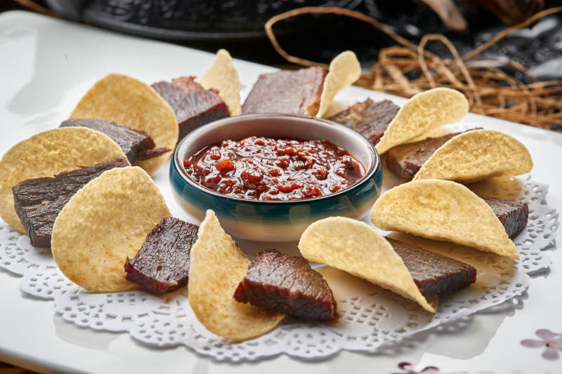 白色瓷盘装的蘸酱脆香牛瓜条配薯片