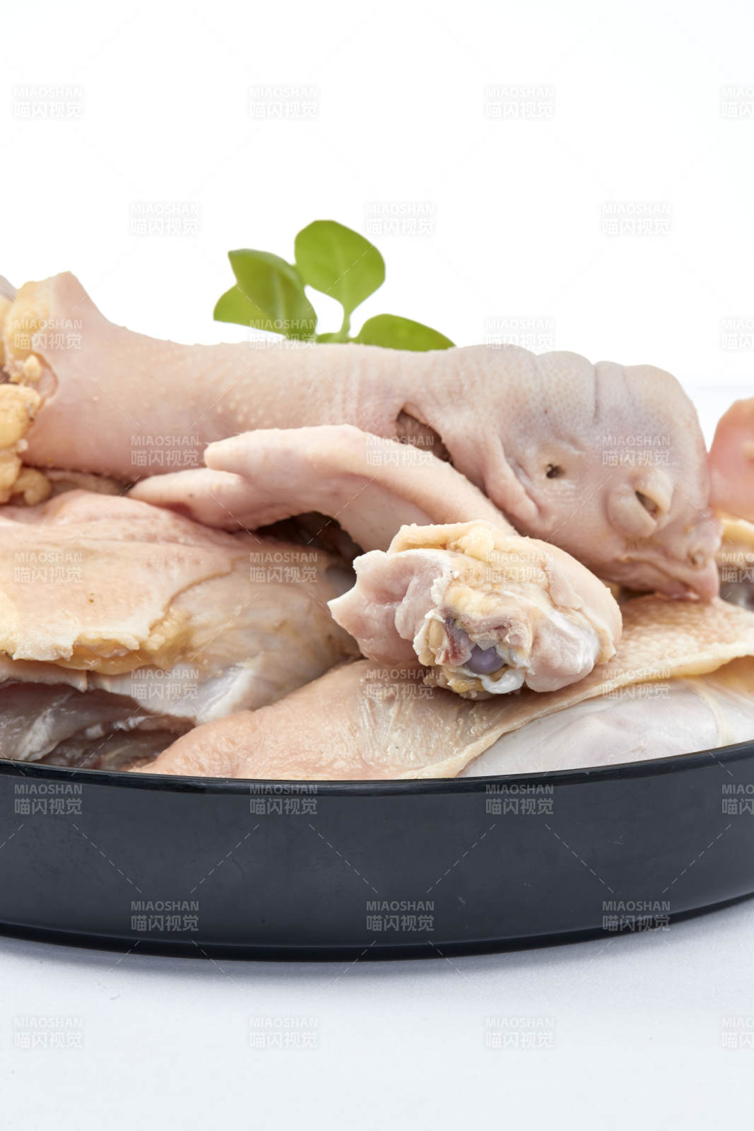 摆放在白色背景上分切好的生鲜鸡腿