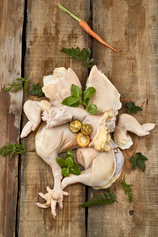 摆放在木板上的分切好的生鲜鸡肉