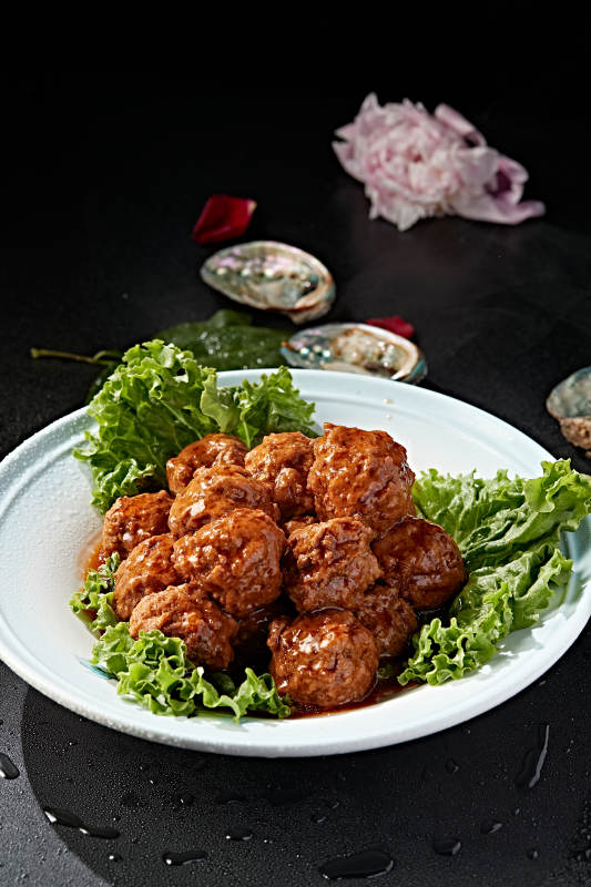 白色瓷盘装的红烧丸子